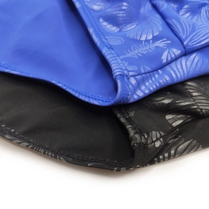 Close-up of quick-dry fabric and silver leaf print on professional men's swim briefs