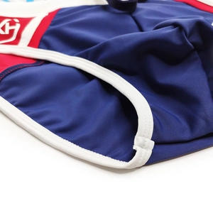 Close-up of sporty swim briefs with contrast red panels and white edge stitching details