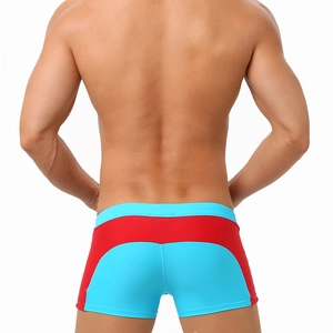 Back view of professional men's swimming trunks with blue and red color-block design