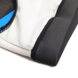 Close-up of professional reinforced stitching and elastic fabric on striped swim briefs