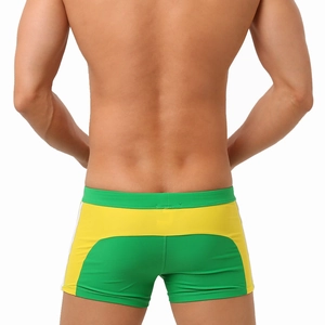 Rear view of tight-fitting men's swim trunks with green and yellow color-block design