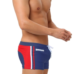 Detail of men's swim trunks with drawstring waist and functional zipper pocket