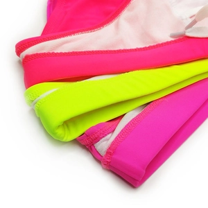 Detail of neon swim briefs showing vibrant fabric textures and white drawstring waist