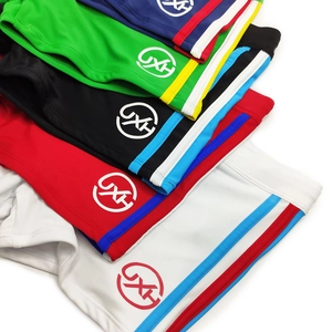 Pile of colorful men's swimming trunks showing striped sides and high-stretch fabric details