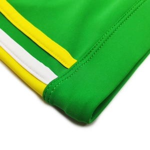 Close-up of bright green fabric with yellow and white side stripes and fine stitching