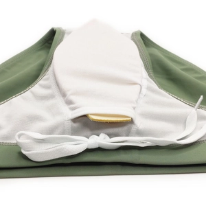 Detail of army green swimwear with breathable white mesh lining and protective pad pocket