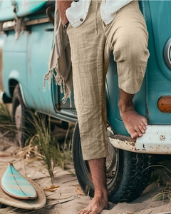 Detail of khaki linen texture on men's drawstring shorts during an outdoor beach photoshoot