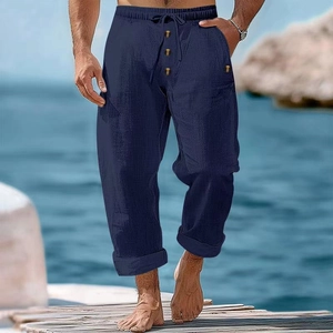 Detail of navy blue cotton linen trousers showing drawstring waist and decorative buttons