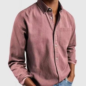 Detailed view of dusty rose linen shirt texture with chest pocket and white buttons