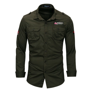 Detail of dark green cotton military shirt featuring dual chest pockets and shoulder epaulettes