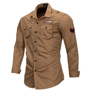 Detail of khaki cotton outdoor shirt featuring military patches and chest pockets