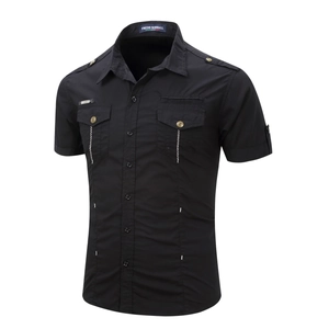 Detail of black military work shirt featuring buttoned chest pockets and shoulder epaulettes