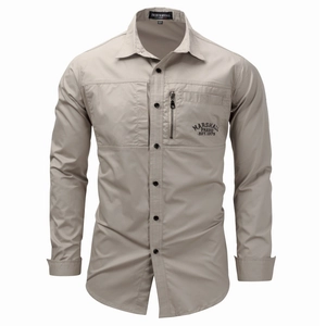 Close-up of tactical khaki shirt featuring a vertical zipper pocket and vintage chest print