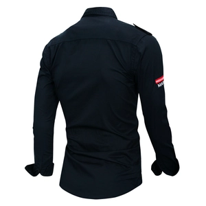 Detail view of cotton outdoor shirt featuring shoulder epaulettes and brand sleeve patch