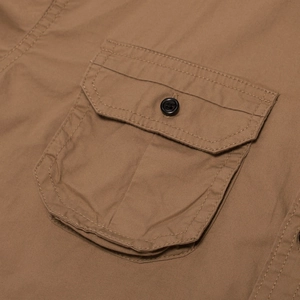 Detailed view of the tactical cotton shirt's cargo pocket with reinforced stitching