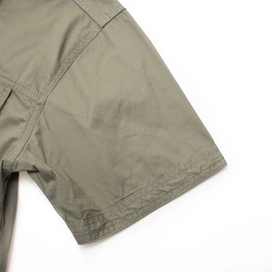 Detailed macro view of army green cotton twill sleeve with durable double-needle stitching