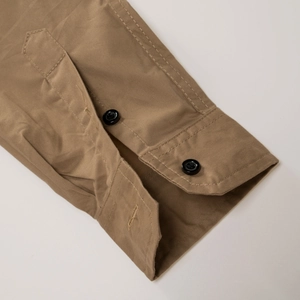 Detail of adjustable double-button cuffs on khaki cotton military outdoor shirt for men
