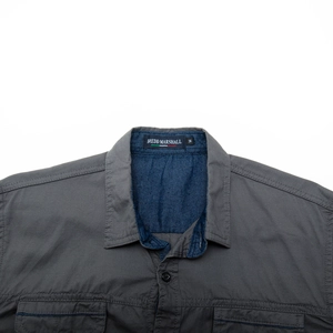 Close-up of shirt collar and shoulder showing denim lining and high-quality cotton texture