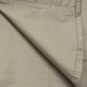 Macro view of twill cotton fabric with durable double-needle stitching and khaki texture