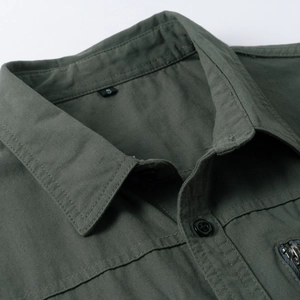 Detail of army green cotton work shirt featuring turn-down collar and metal zipper pocket