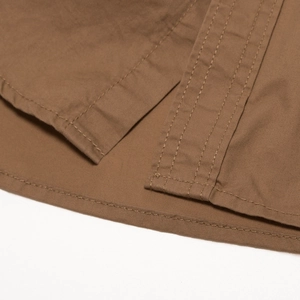 Detail view of cotton outdoor shirt with side slits and triple-stitched hem reinforcement