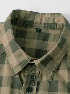 Detailed view of the military green checkered cotton shirt collar with embroidered logo and size S tag