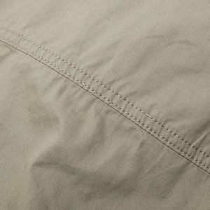 Macro detail of khaki cotton twill fabric with precise double-needle parallel stitching