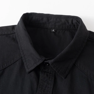 Close-up of black cotton shirt collar and shoulder with durable double-stitched seams