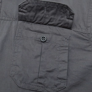 Macro detail of charcoal grey cotton twill cargo pocket with reinforced double stitching