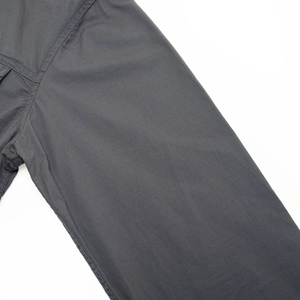 Detail view of double-stitched cuffs on heavy-duty charcoal grey cotton military shirt