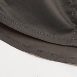 Macro shot of durable fabric with precise double-needle stitching on military style shirt
