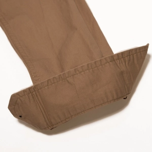 Macro detail of brown cotton twill shirt cuff showing durable stitching and heavy fabric