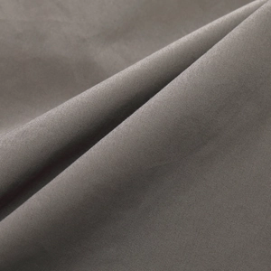 Detailed close-up of dark grey tactical shirt fabric with smooth satin texture