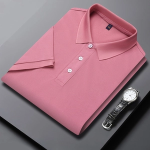 Detail of coral pink pique polo shirt with three-button placket and matching wrist watch