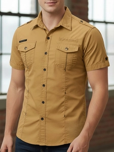 Detail of men's mustard yellow cotton cargo shirt featuring epaulettes and chest pockets