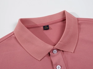 Detail of dark pink polo shirt showing pique cotton texture and two-button collar