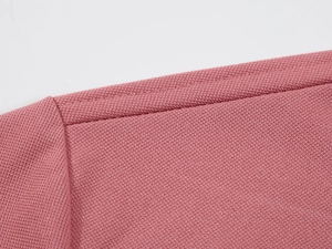 Detailed macro view showing pink breathable mesh fabric texture and durable double stitching
