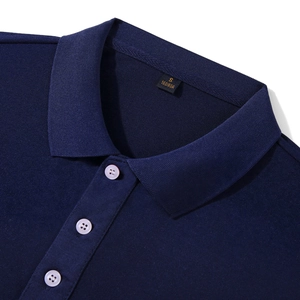 Detailed macro view of navy blue piqué cotton polo shirt collar with pearl buttons