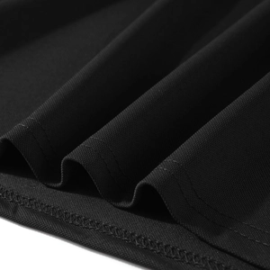 Macro shot of black breathable polo shirt fabric with detailed stitching and texture