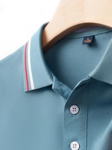 Close-up of the breathable pique polo collar with red and white striped edge details