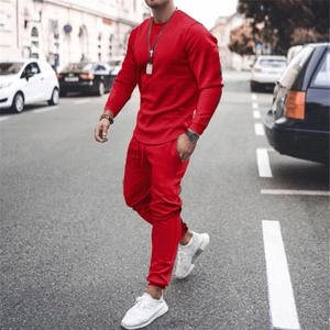 Action shot of men's bright red long-sleeve tracksuit with joggers on a city street