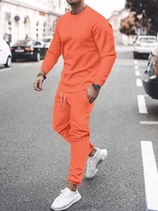 Men's orange casual long sleeve sweatshirt and drawstring jogger set on city street