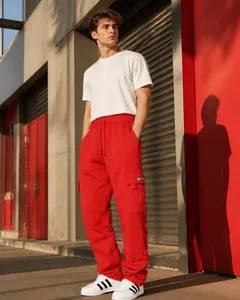 Detail of red cargo joggers showing elastic waistband and side pocket with small woven label