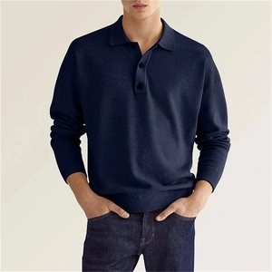 Detail of navy blue long sleeve polo shirt showing premium fabric texture and button collar