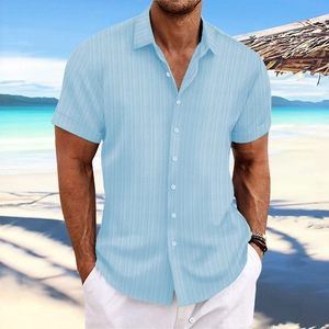 Detail of light blue men's cotton linen shirt with vertical stripes in a beach setting