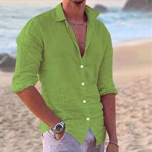Detail of lime green men's linen shirt showing texture and white buttons on beach