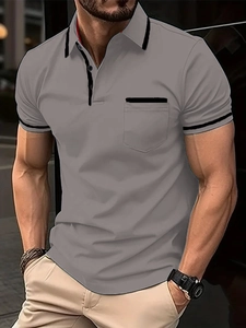 Detail view of men's polo shirt showing contrast collar and black trim chest pocket