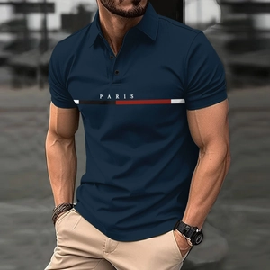Detalle de polo para hombre azul marino con texto Paris y rayas tricolores en el pecho