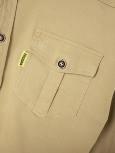Detail of khaki twill cotton shirt showing chest pocket, dark button and fashion label