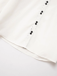 Detail of white business shirt hem with black double buttons and curved cut design
